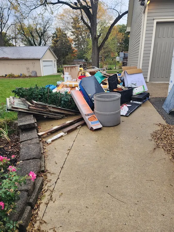 Dumpster being loaded with debris for Demolition Dumpster Rental in Carrizo Springs